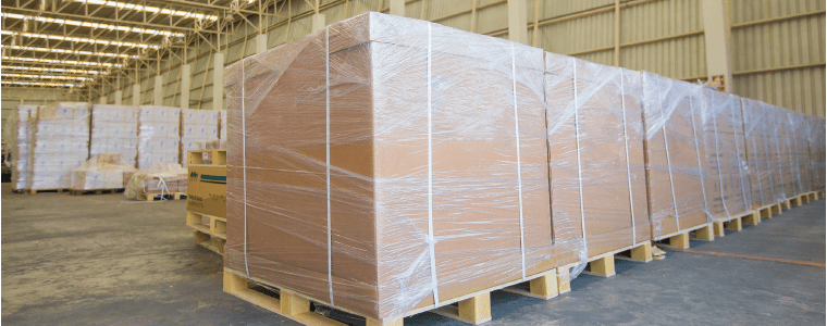 auto_featured boxed cargo sitting on pallets in a warehouse