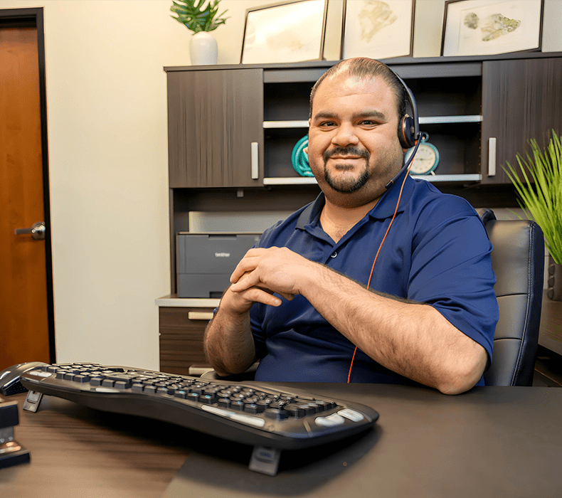 790×700 our difference manager working at desk with keyboard